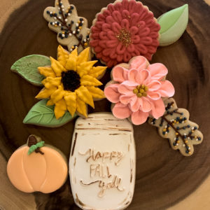 Mason jar cookies with flowers and a pumpkin