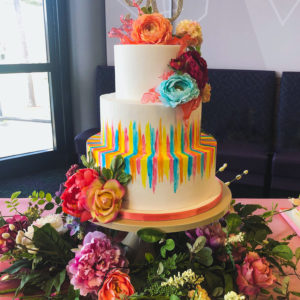 Painted tiered cake with pulled sugar and silk flowers