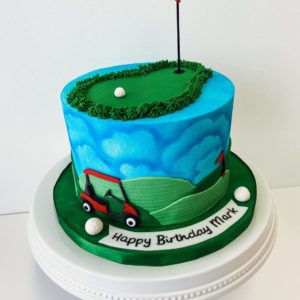 Small golf themed birthday cake with golf cart and airbrushed clouds. 