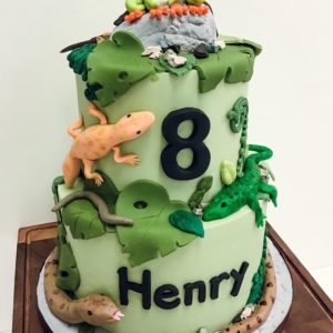 Tiered cake with molded lizards, frogs, snakes and worms. 