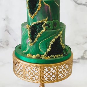 Tiered marble cake with gold and green edible crystals. 