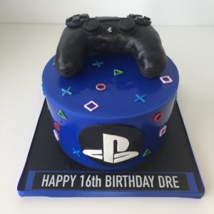Playstation themed cake with controller on top
