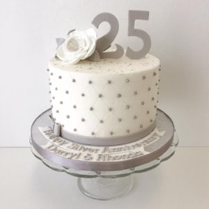Small buttercream cake with silver pearls. 