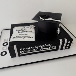 A black and silver book graduation cake.