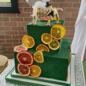 A green buttercream square cake with dried citrus as decoration 