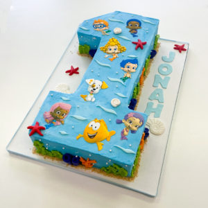 #1 shaped cake with Bubble Guppies characters on top