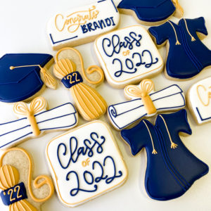 Navy and gold colored grad cookies