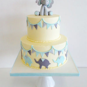 Yellow buttercream cake with fondant bunting and elephant on top