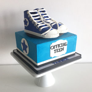 Fondant molded shoes on top a buttercream square cake