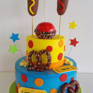 A carnival themed birthday cake with molded fondant food