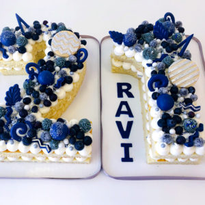 21 shaped cake topped with blueberries, cake truffles, chocolates and more