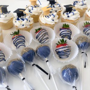 Grad cupcakes with chocolate covered strawberries and cake pops