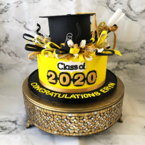 Graduation cake with confetti bursting from the cap 