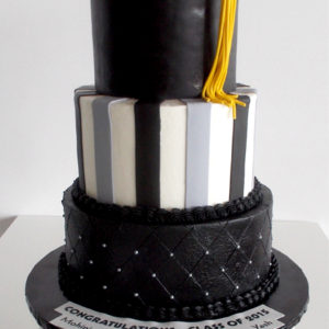 Three tiered fondant cake with silver pearls and an edible hat on top