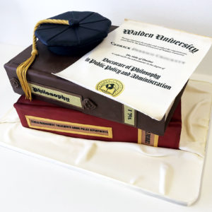 Doctorate graduation with 2 large books, edible diploma and doctorate style grad hat