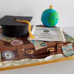 Luggage cake with grad cap and globe on top