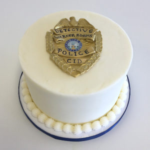 Simple cake with a fondant badge
