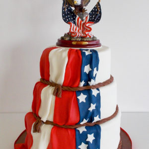 A three tiered retirement cake with an American flag down the cake