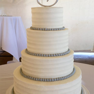 Tall white cake with grey bead border